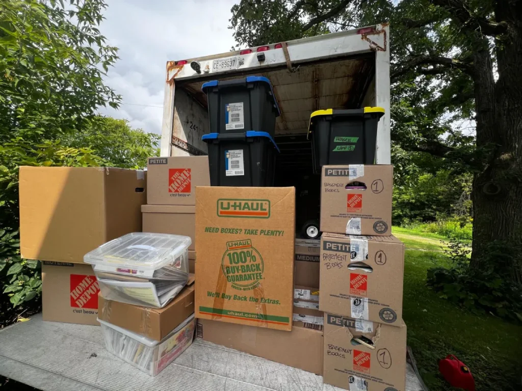 Professional movers loading packed household boxes into a moving truck in Vancouver